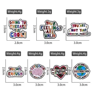 Set of 7 mental health enamel pins with motivational quotes on a white background