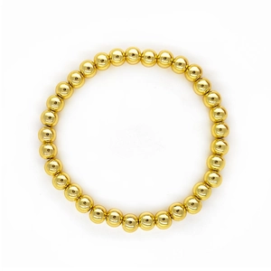 Detail of 18K gold-plated beaded stretch bracelet with high-shine metallic finish