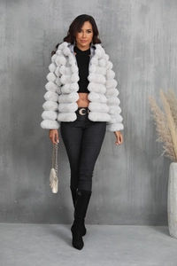 Detailed plush texture of light gray faux fur coat styled with black outfit