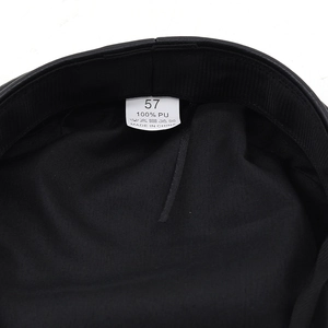Detail view of the black PU leather cap lining with size 57 and 100% PU material label
