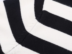 Detailed close-up of striped knit fabric showing high-quality texture and stitching