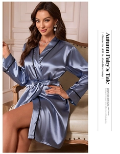 Close-up of luxury silk robe in grey-blue with black trim and elegant waist tie details