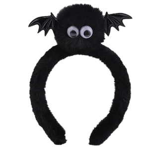 Close-up of black plush bat headband with spring antennae and big eyes for Halloween party