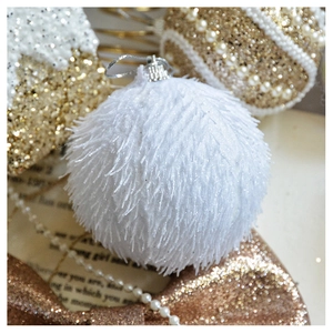 Close-up of fluffy white Christmas ornament ball with a soft plush texture and silver hanger