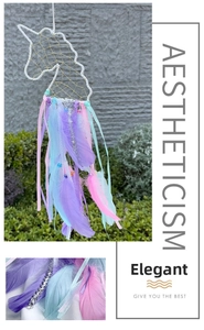 Detailed close-up of soft purple and pink feathers on the unicorn dream catcher