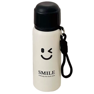 Minimalist stainless steel insulated tea bottle with smile icon and black handle strap