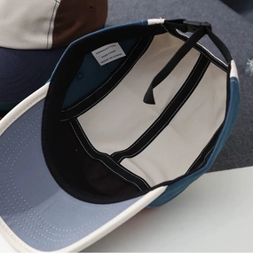 Detail showing the inner structure, 100% cotton material, and adjustable strap of the camper hat