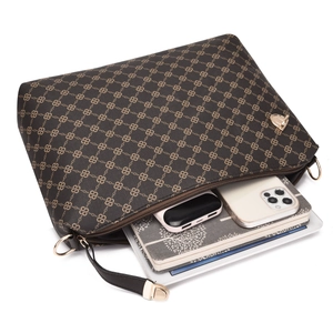 Detail of printed crossbody bag showing large storage capacity for tablets and phones