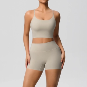 Detail of sand-colored seamless yoga set featuring thin strap sports bra and high-waist shorts