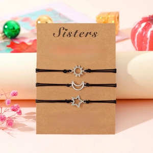 Three-piece sun moon and star sisters wish bracelets set on a pink gift display card
