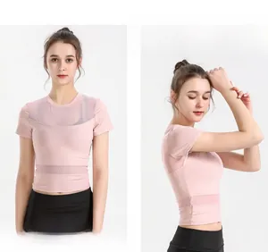 Detail of light pink cropped sports top featuring breathable mesh panels for yoga training