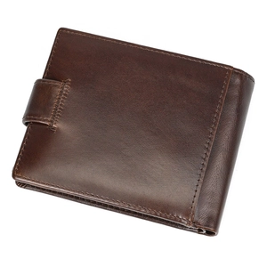 Close-up of genuine dark brown leather wallet showing fine texture and neat stitching
