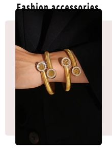 Detailed view of 18k gold plated tree of life bangles with crystals on a female wrist