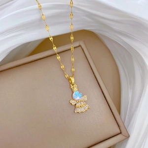 Detailed macro shot of a gold angel necklace with a colorful aurora crystal pendant