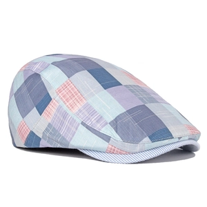 Detail of colorful plaid patchwork flat cap showing breathable cotton linen texture