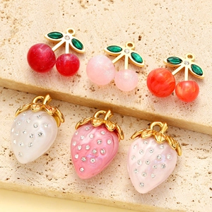 Handmade fruit pendants in strawberry and cherry designs with crystal accents on stone