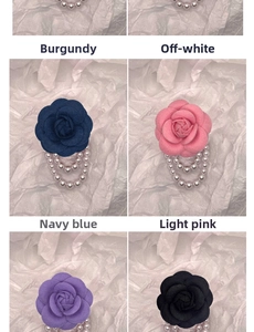 Detailed view of camellia fabric brooches with triple pearl chains in various colors