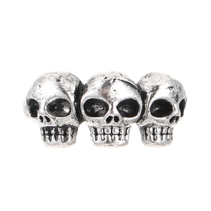 Detailed view of three gothic skulls on an antique silver vintage style ring band