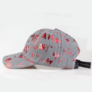 Detail of grey baseball cap showing red reflective graffiti print and stitching