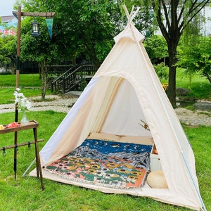 Detail of bohemian woven blanket with sunflower pattern inside an outdoor teepee tent