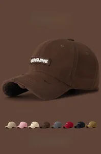 Detail of distressed brim and SUNSHINE embroidery on vintage washed cotton baseball cap