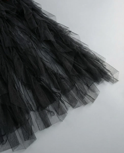 Detail of layered black mesh tulle fabric on a luxury evening gown for party wear