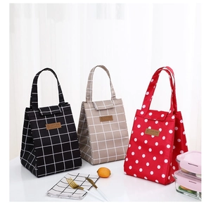 Insulated canvas lunch bags in plaid and polka dot patterns with zipper handles