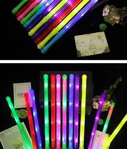 Macro shot of colorful glowing LED foam sticks illuminating in dark party setting