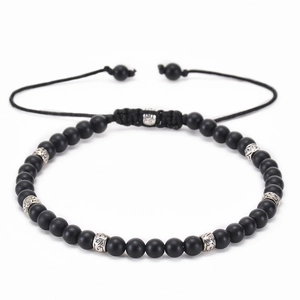 Detail of adjustable black matte stone bracelet with engraved silver metal beads