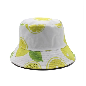 Summer bucket hat with vibrant lemon print and green leaves on white canvas background