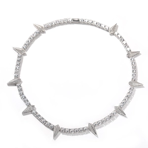 Detailed view of silver tennis chain necklace with spiked zircon pendants on white background