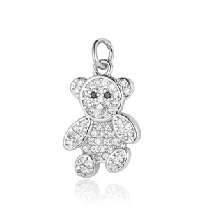 Macro shot of silver teddy bear pendant with sparkling zircon inlays on white background