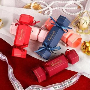 Close-up of candy-shaped gift boxes in red, blue and pink with elegant ribbons