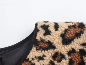 Detailed close-up of leopard print fleece jacket collar with black trim and smooth lining