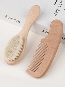 Detailed view of baby hairbrush set with soft goat bristles and natural wooden handle