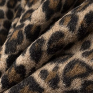 Macro shot of faux fur leopard print fabric texture showing soft plush velvet material