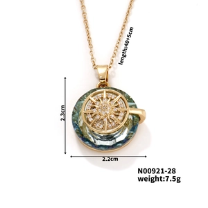 Detail view of gold compass necklace with teal crystal pendant showing size dimensions
