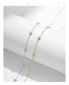 Detail of s925 silver four-leaf clover necklaces in gold and silver with zircon accents