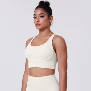 Detail of high-waist seamless leggings and U-neck sports bra set in cream white