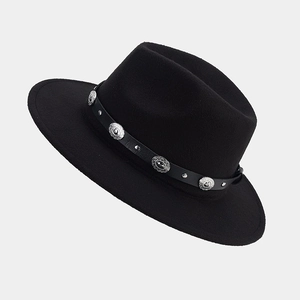 Détail du chapeau fedora noir avec boucle argentée et bande en cuir cloutée