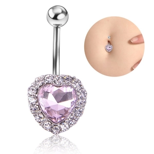 Detail of pink heart-shaped belly button ring with silver cubic zirconia surrounding