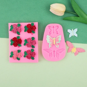 Detail of pink silicone molds for rose and butterfly fondant with finished craft examples