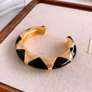 Vintage black enamel and gold plated open cuff bracelet with vertical striped texture