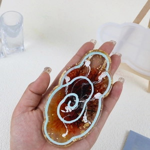 Cloud-shaped resin tray with orange marble texture and gold foil in a DIY silicone mold set