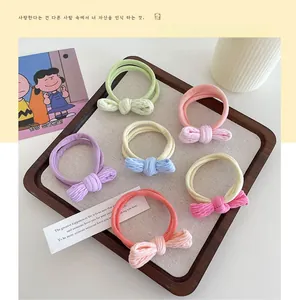 Set of six high-elastic bow hair ties in pastel macaron colors displayed on a wooden tray