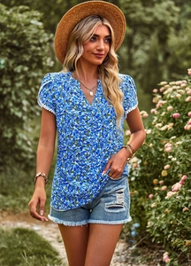 Elegant V-neck floral blue blouse with delicate white lace trim on sleeves and hemline