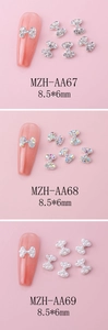 Detailed view of silver bow-knot nail charms with crystals and pearls in 8.5x6mm size