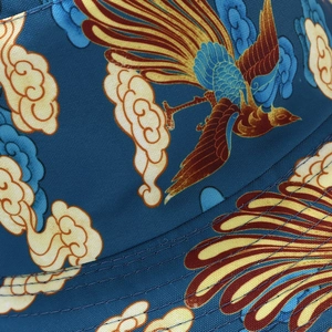 Detailed close-up of colorful Chinese phoenix embroidery on navy blue twill sun hat fabric
