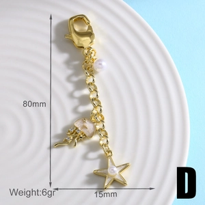 Detail showing gold sun jellyfish keychain with sea star pearl charms and length parameters