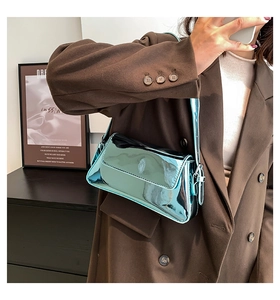 Metallic sky blue baguette bag with glossy mirror finish worn with a brown blazer